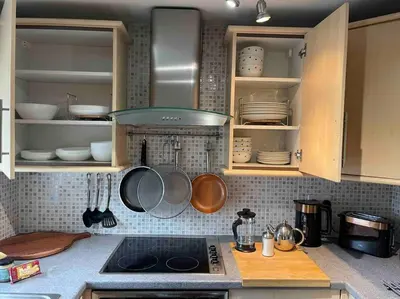 a kitchen with cabinets with pans and utensils at Yew Tree Cottage, 3 bedroom, 4 Church Row Defynnog in Devynock