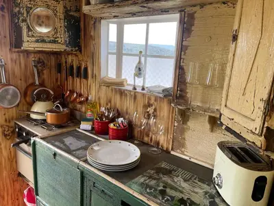 a kitchen with a stove and a window in it at Ty Gwenyn, Coity Bach in Brecon