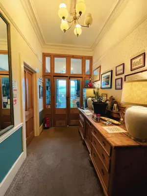 a large room with a desk and a chandelier at Wavecrest in Barmouth