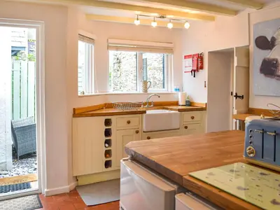 a kitchen with a sink and a counter at Penlan Cottage in Cwrt-newydd