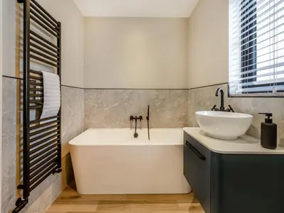 a bathroom with a white tub and a sink at The Lara - Uk45019 in Mochdre