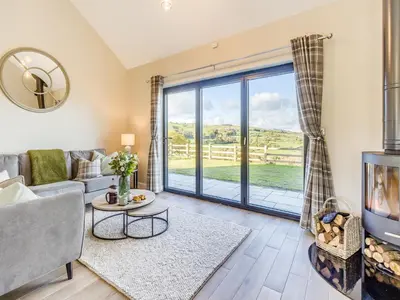 a living room with a couch and a fireplace at The Warne - Uk45018 in Mochdre