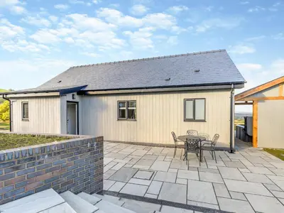 a patio with a table and a building at The Warne - Uk45018 in Mochdre