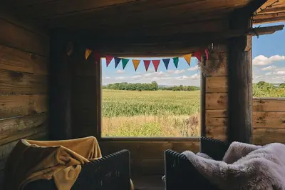 a room with a window with a view of a field at Curious Calf in Leominster