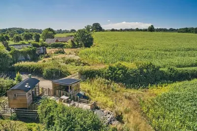 an aerial view of a cabin in the middle of a field at Curious Calf in Leominster