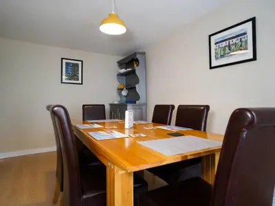 a conference room with a wooden table and leather chairs at Characterful 3 Bedroom Cottage in Aberystwyth