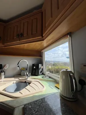 a kitchen with a sink and a large window at Holiday Home by the sea in Aberystwyth
