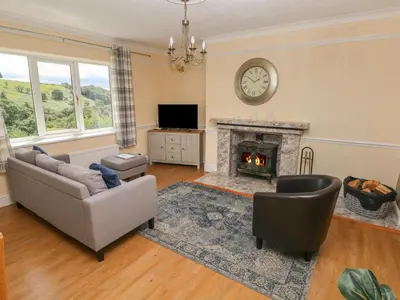 a living room with a couch and a fireplace at Hillside Lodge in Llandrindod Wells