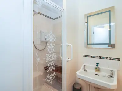 a bathroom with a shower and a sink at Dinham Court in Ludlow