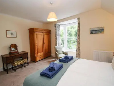 a bedroom with a bed with blue towels on it at Dinham Court in Ludlow