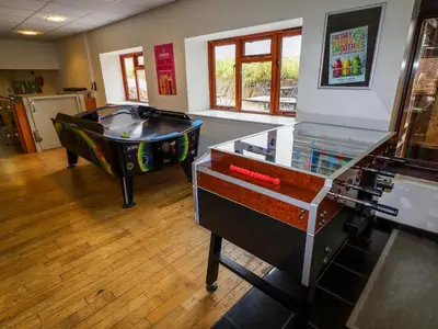 a room with a ping pong table and a pool table at Grove Cottage in Leominster