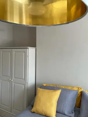 a gold chandelier hanging over a blue couch at Northampton House in Llanwrtyd Wells