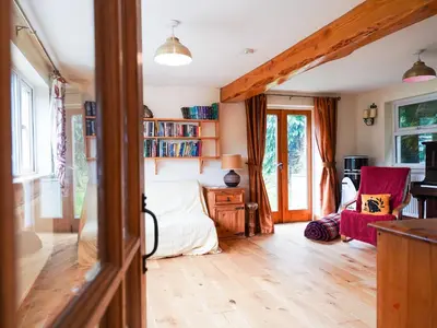 a room with a bed and a desk and chairs at Delfryn, Goginan in Aberystwyth