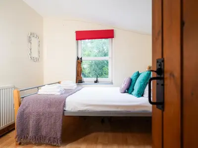 a bedroom with a bed and a window at Delfryn, Goginan in Aberystwyth
