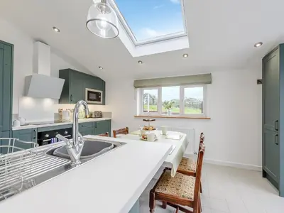 a kitchen with a sink and a skylight at Maesyrhaf in Llanllwchaiarn
