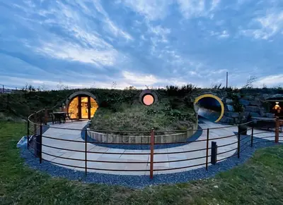 a house with a garden in the middle of a field at Honeybee Home in Llansantffraid-ym-Mechain