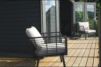 two chairs sitting on the porch of a house at Penestaer in Machynlleth
