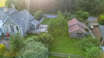 an aerial view of a house with a yard at St Marks School House in Llanwrthwl