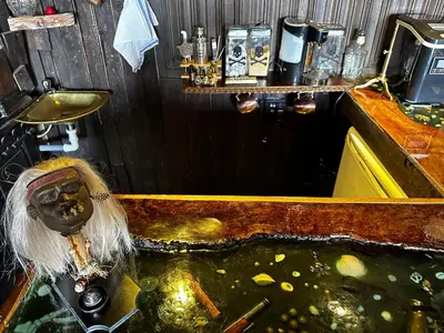 an overhead view of a bar with a fish pond at Coed Y Ddraig - themed 3 bedroom cottage, with bar & pool table in Tregaron