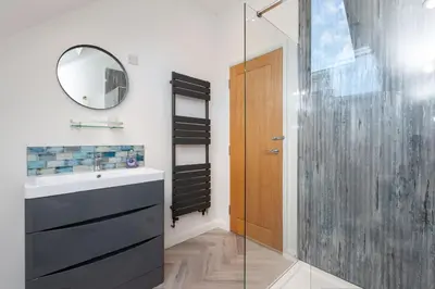 a bathroom with a sink and a mirror at The Caradoc in Shrewsbury