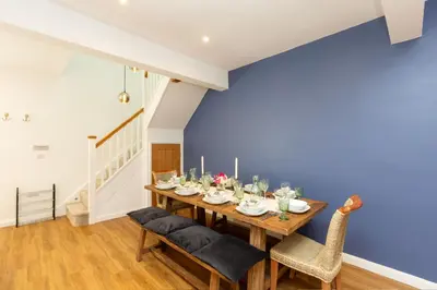 a dining room with a wooden table and chairs at The Caradoc in Shrewsbury
