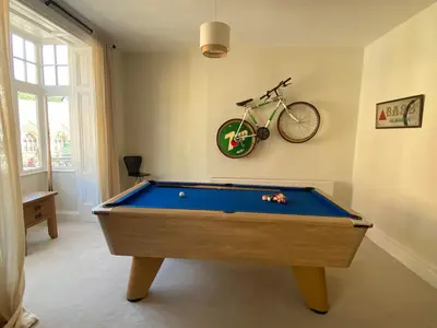 a room with a pool table and a bike on the wall at Brooklands Guest House in Llandrindod Wells
