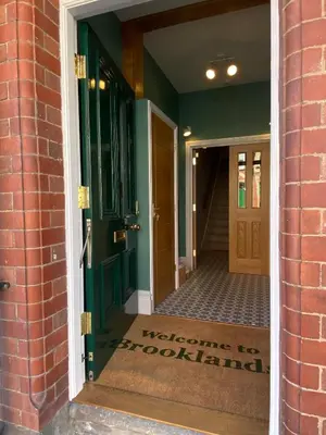 a doorway to a building with a green door at Brooklands Guest House in Llandrindod Wells