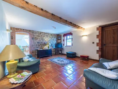 a living room with blue couches and a brick wall at Hidden Gem in Stunning Location - Pass the Keys in Cressage