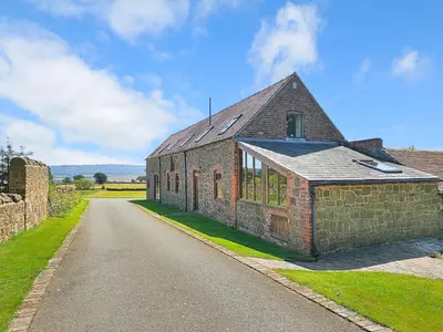 an old brick building with a road in front of it at Hidden Gem in Stunning Location - Pass the Keys in Cressage