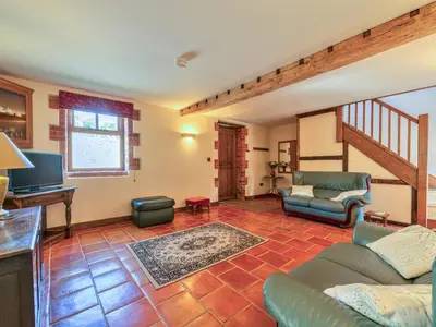 a living room with a couch and a tv at Hidden Gem in Stunning Location - Pass the Keys in Cressage