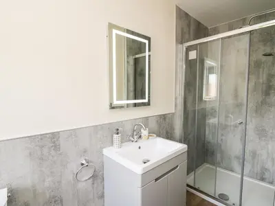 a bathroom with a sink and a shower at Awel y Bryn in Rhayader
