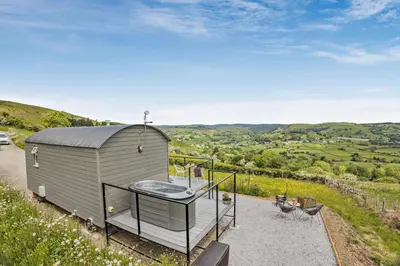 a tiny house on a hill with a hot tub at 1 Bed in Llangadfan oc-c27292 in Llangadfan
