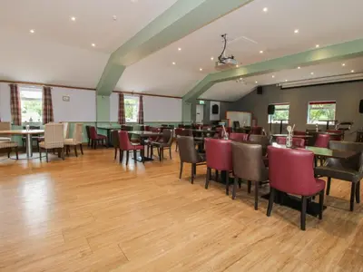 a restaurant with tables and chairs in a room at Heron in Leominster