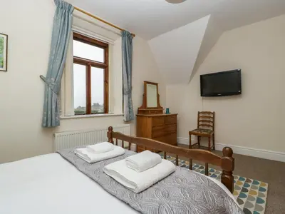 a bedroom with a bed with two pillows on it at Keepers Cottage in Leominster