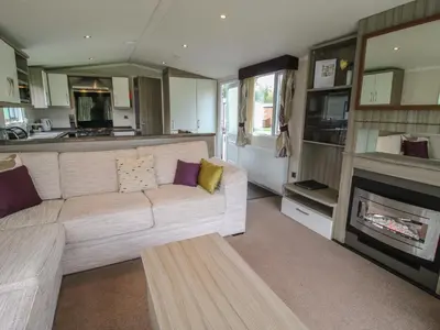a living room with a couch and a fireplace at Swan in Leominster