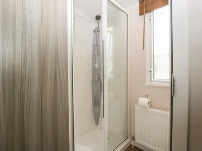 a shower with a glass door in a bathroom at Swan in Leominster