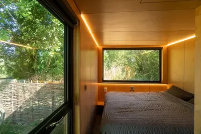 a small bedroom with a bed and a window at Beautiful cabins in Herefordshire countryside in Hereford