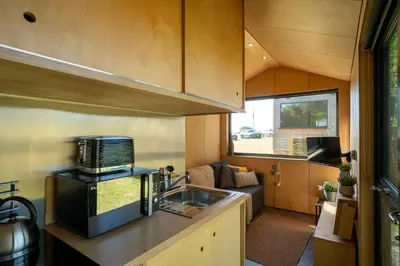 a kitchen with a sink in a tiny house at Beautiful cabins in Herefordshire countryside in Hereford