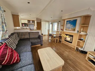 a living room with a couch and a table at Caravan 4 - Cambrian Coast Caravan Park in Borth