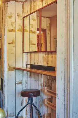 a stool sitting in front of a mirror at Powk Meadow Farmhouse in Leominster