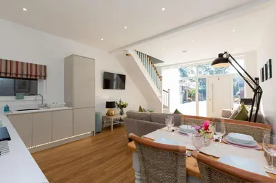 a kitchen and living room with a table and chairs at The Lawley in Shrewsbury
