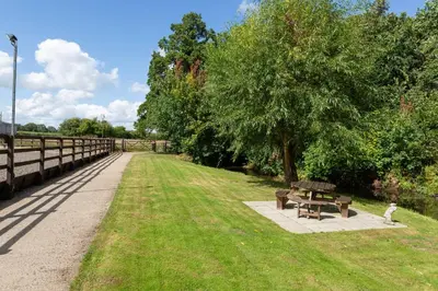 a park with a picnic table and a tree at The Lawley in Shrewsbury