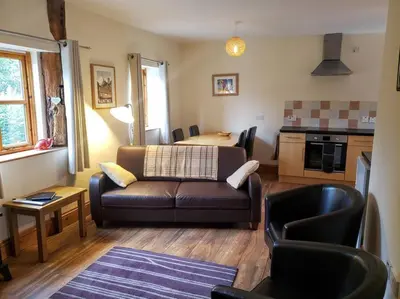 a living room with a couch and a table at Stargazing lodge with amazing views. in Llandrindod Wells