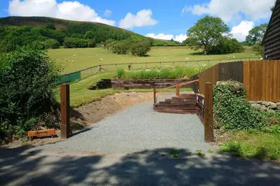 a garden with a wooden fence and some plants at Stargazing lodge with amazing views. in Llandrindod Wells