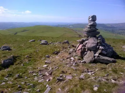 a stack of rocks sitting on top of a hill at Stargazing lodge with amazing views. in Llandrindod Wells