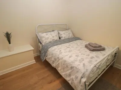 a small bedroom with a bed with a pillow at Bluebell's Cottage in Shrewsbury