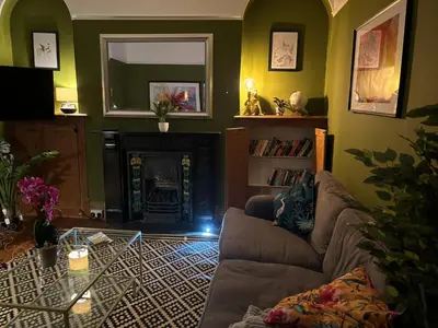 a living room with a couch and a fireplace at Rhianfa 4 bedroom house minutes walk from the beach in New Quay