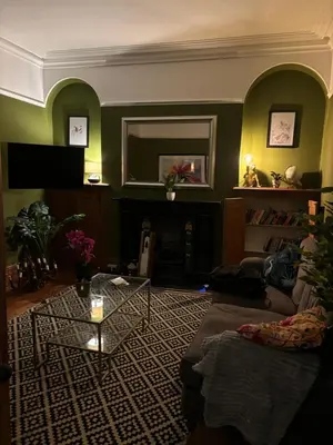 a living room with a couch and a fireplace at Rhianfa 4 bedroom house minutes walk from the beach in New Quay