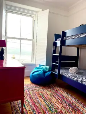 a bedroom with a bunk bed and a bean bag at Rhianfa 4 bedroom house minutes walk from the beach in New Quay