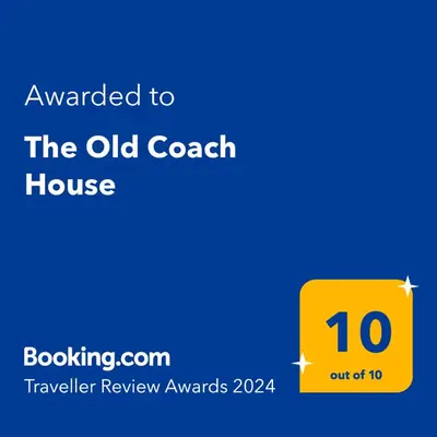 a yellow sign that says awarded to the old coach house at The Old Coach House in Llangollen